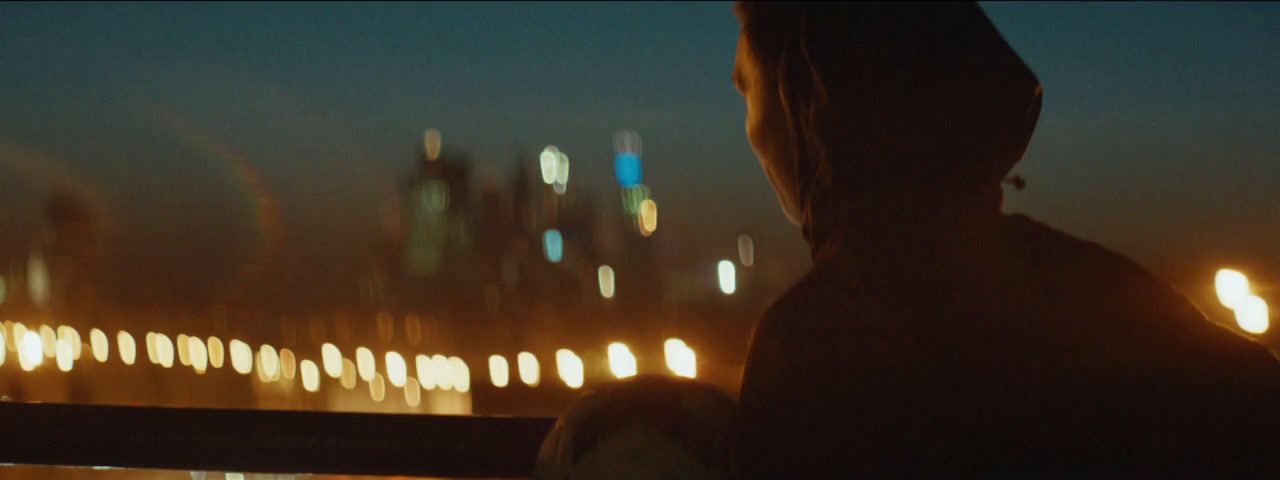 a person looking out over a city at night