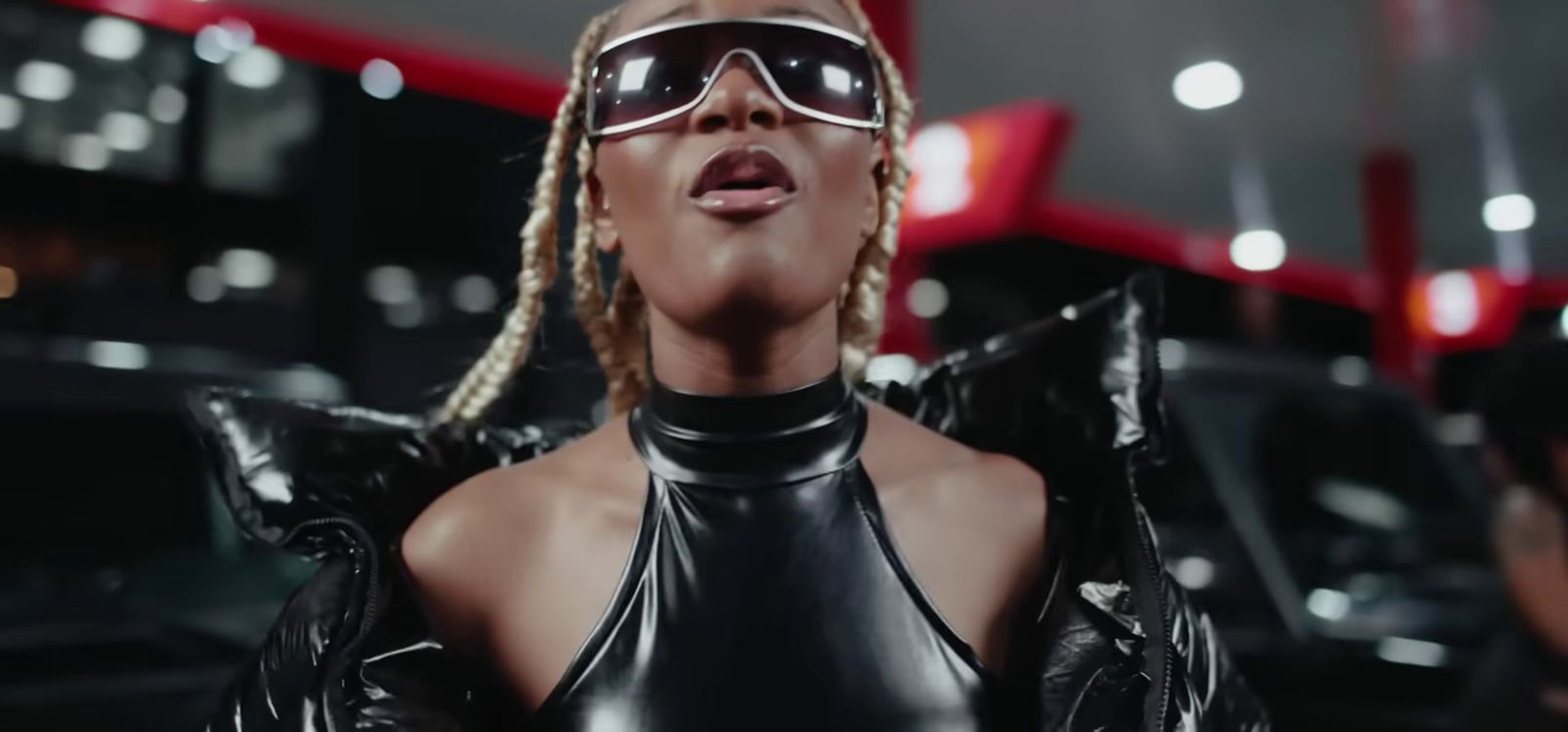 a woman in a leather outfit and sunglasses