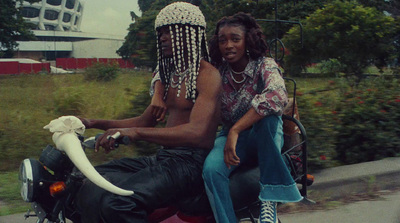 a man and a woman riding on the back of a motorcycle