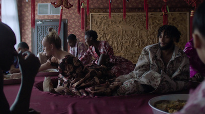 a group of people sitting on top of a bed