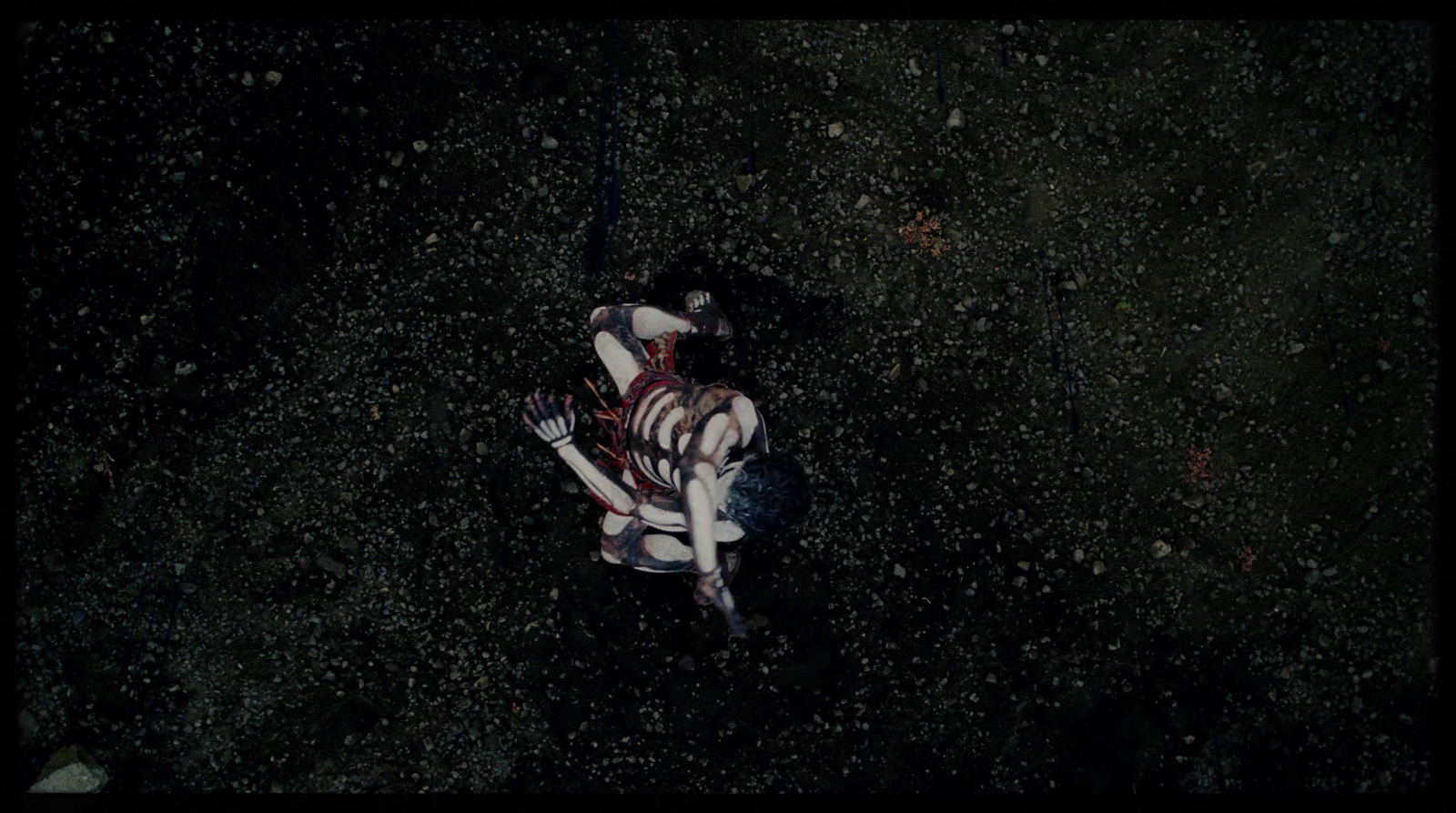 a person laying on the ground in the dark