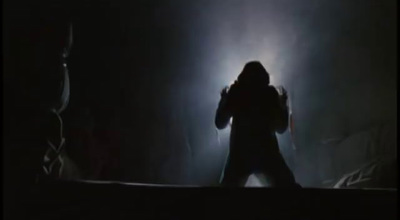 a person standing in a dark room with a light on