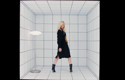 a woman standing in a white tiled room