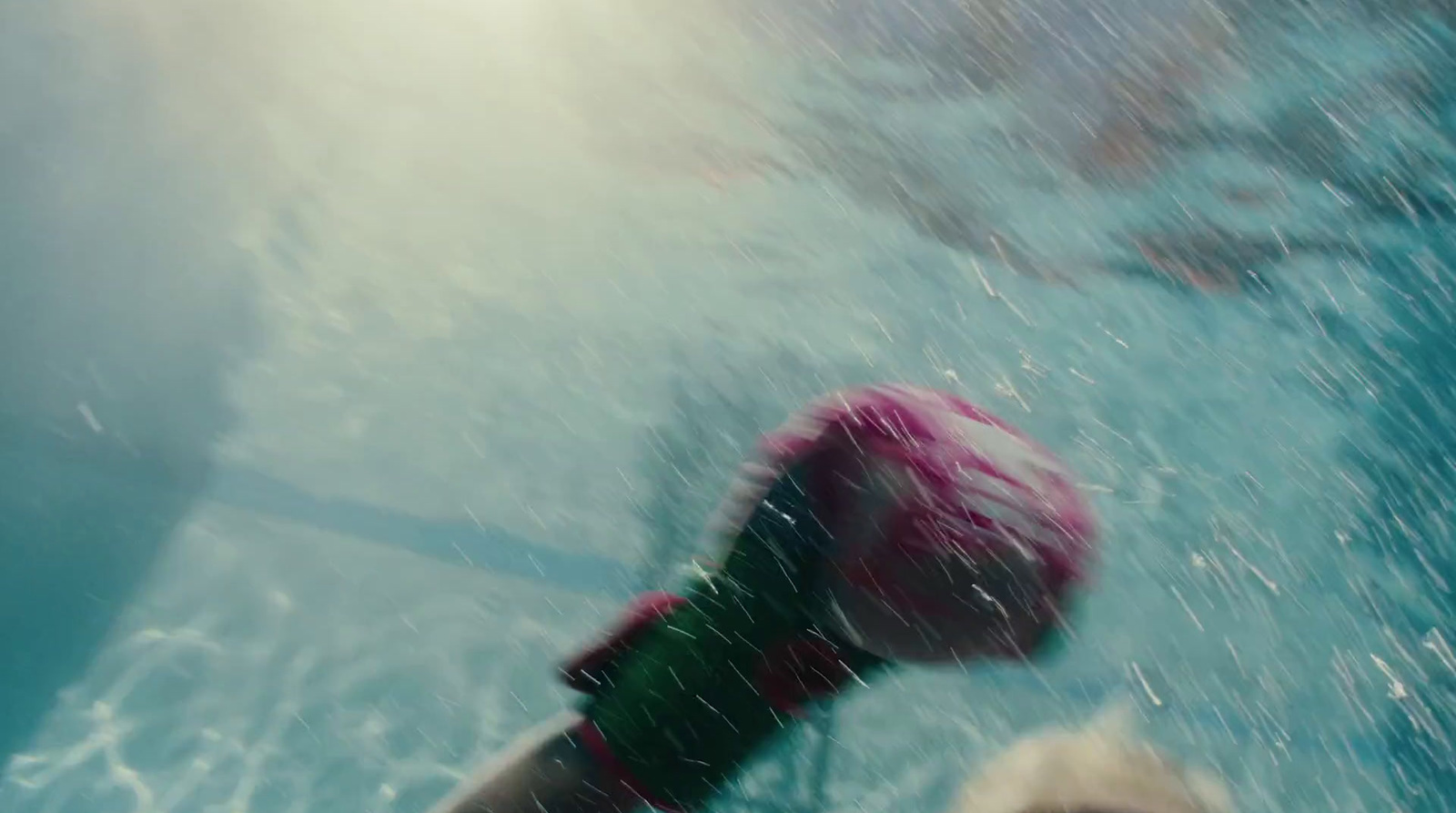 a blurry photo of a person swimming in a pool