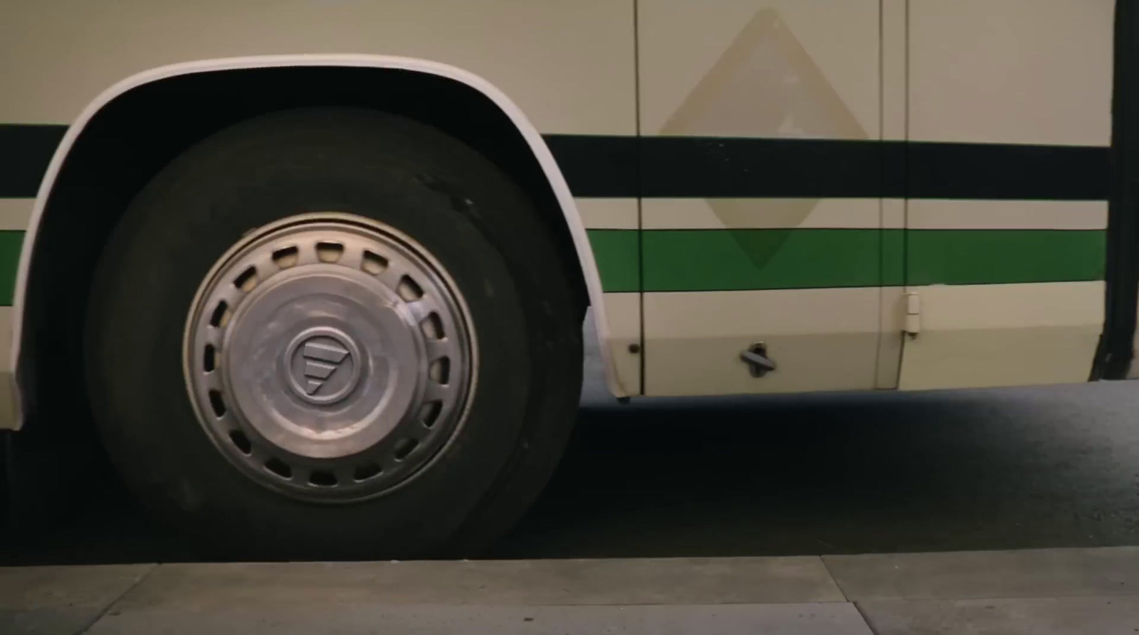 a close up of a bus tire on a city street