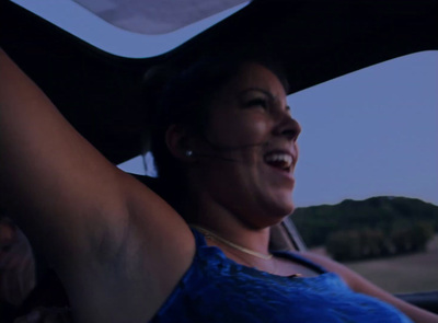 a woman sitting in the back seat of a car