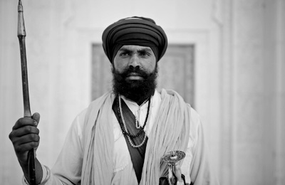 a man in a turban holding a stick