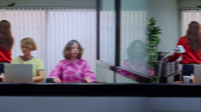 a group of women sitting at a table with laptops