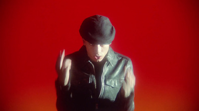 a man in a black leather jacket and hat