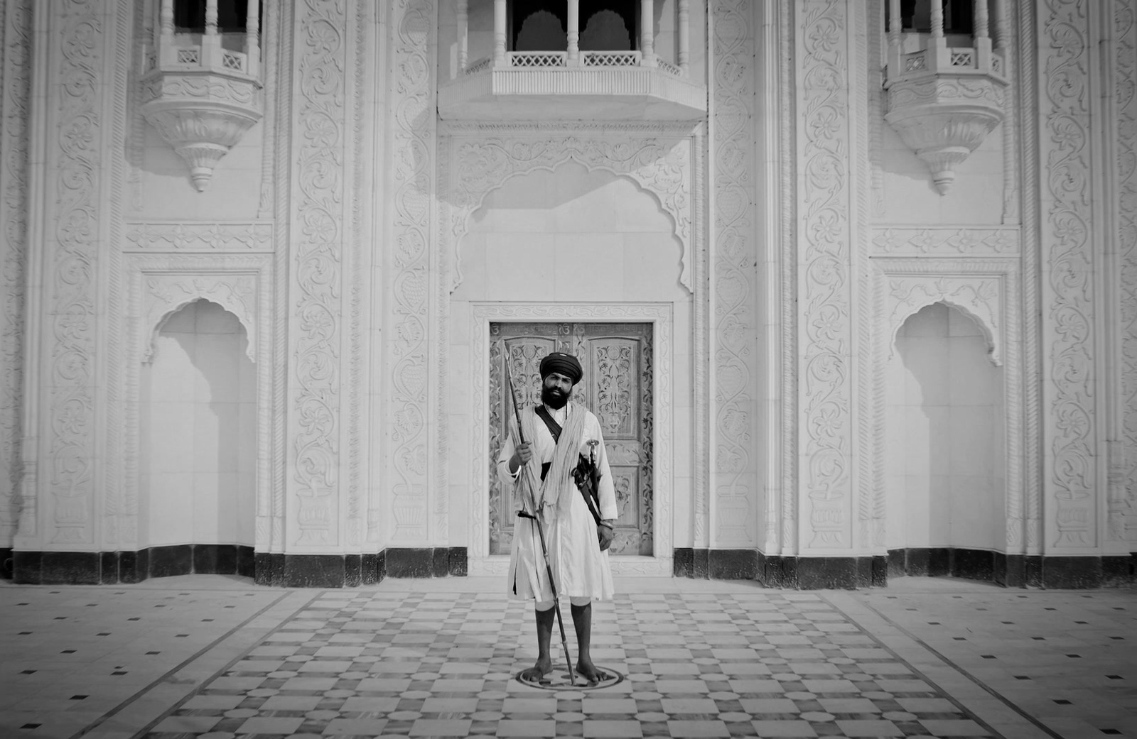 a man standing in front of a tall building