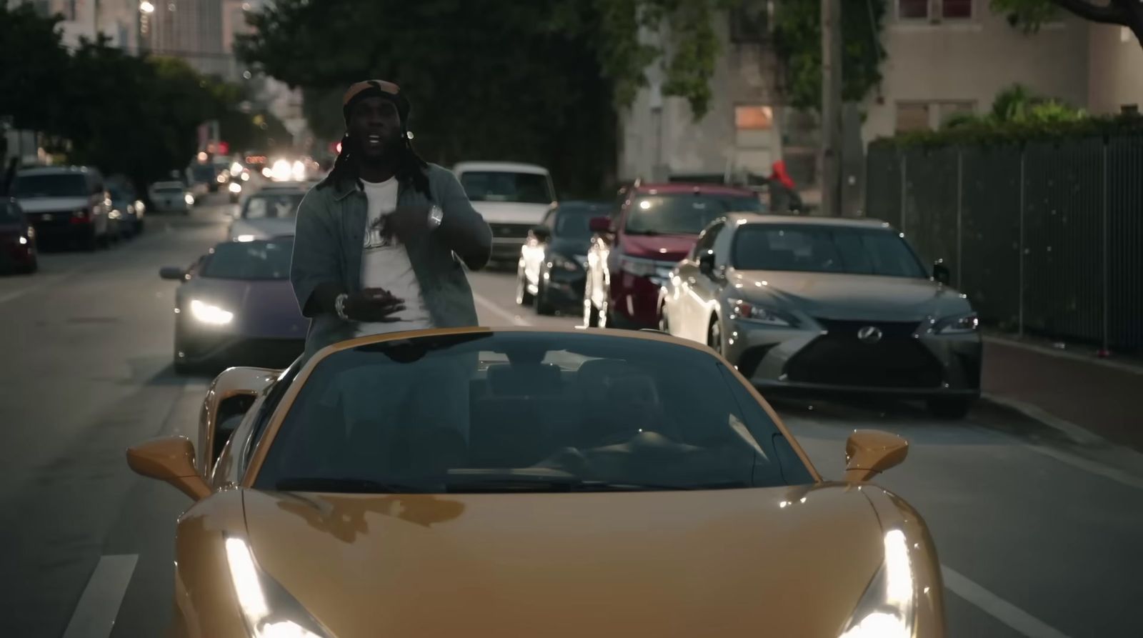 a man riding on the back of a yellow sports car