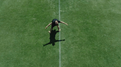 a person standing on a tennis court holding a racquet