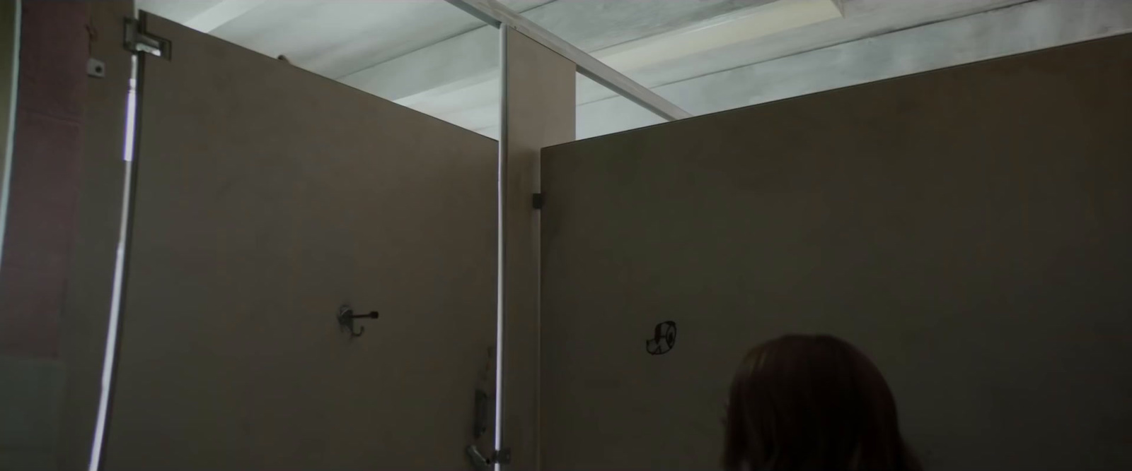 a woman standing in front of a mirror in a bathroom