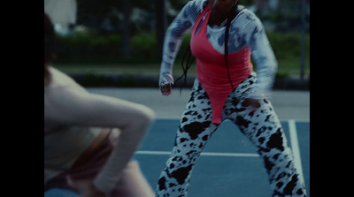 a woman is playing tennis on a court