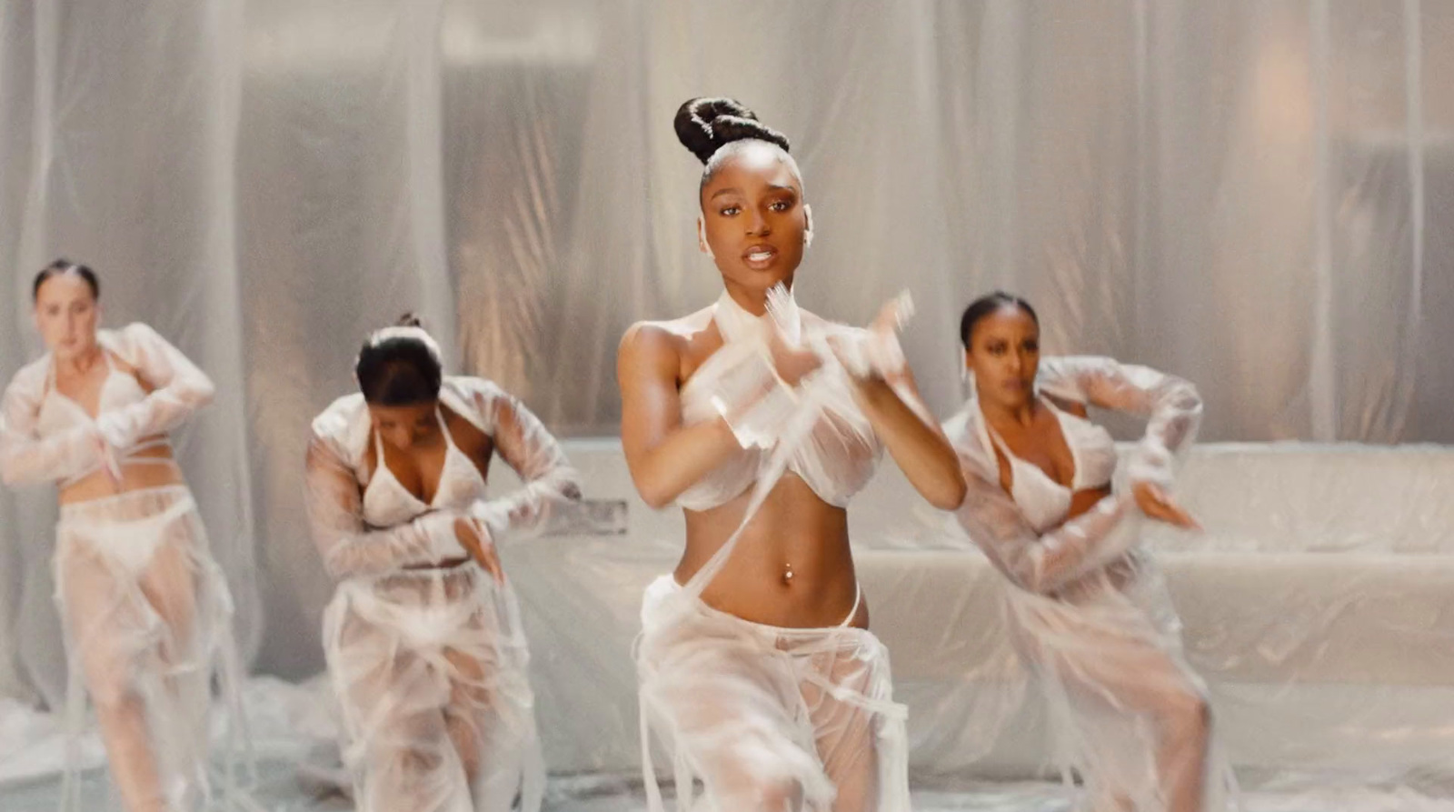 a group of women dancing in white outfits