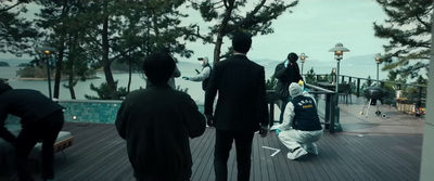 a group of people standing on top of a wooden deck