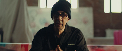 a man in a black shirt and a black hat