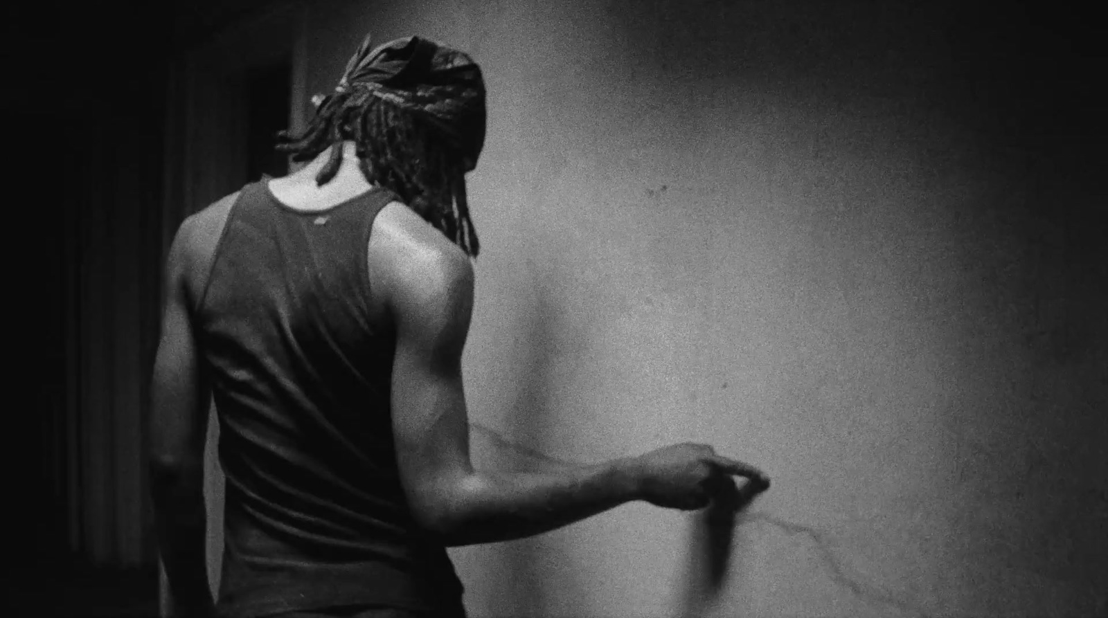 a woman with dreadlocks standing in a room