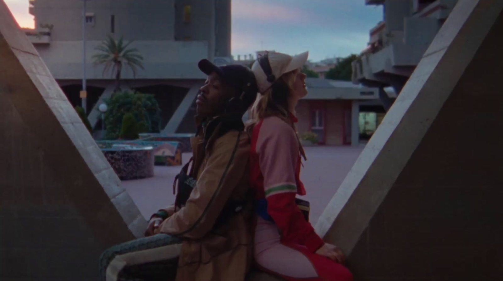 a couple of people sitting on top of a bench