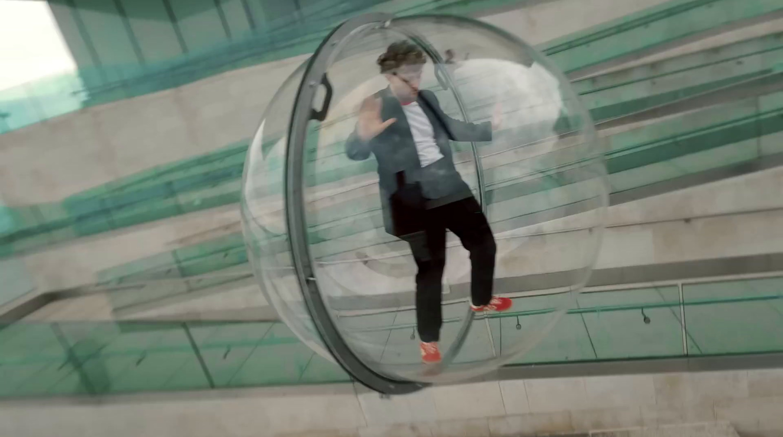 a man standing inside of a glass ball