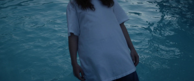 a young girl standing in a pool of water