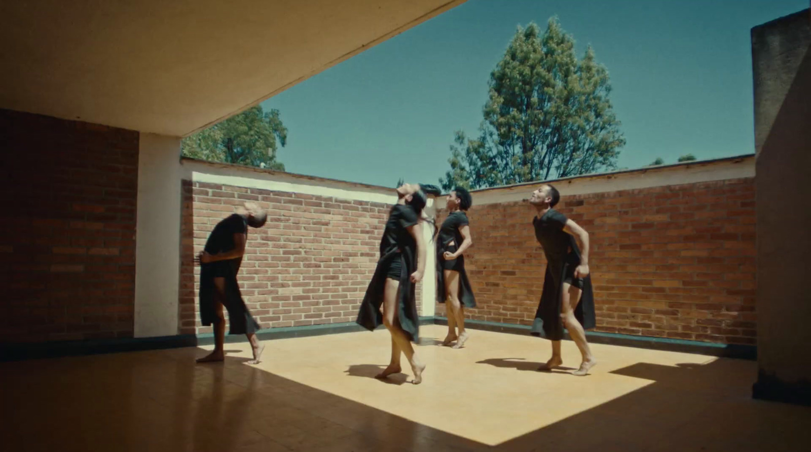 a group of people standing on top of a wooden floor