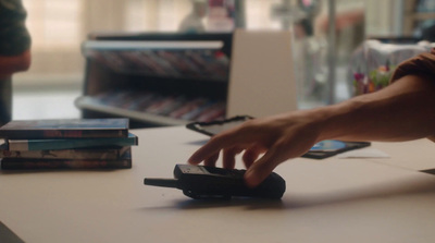 a person using a cell phone on a table