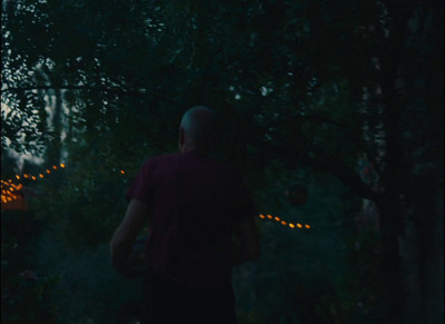 a man standing in the dark with a frisbee in his hand