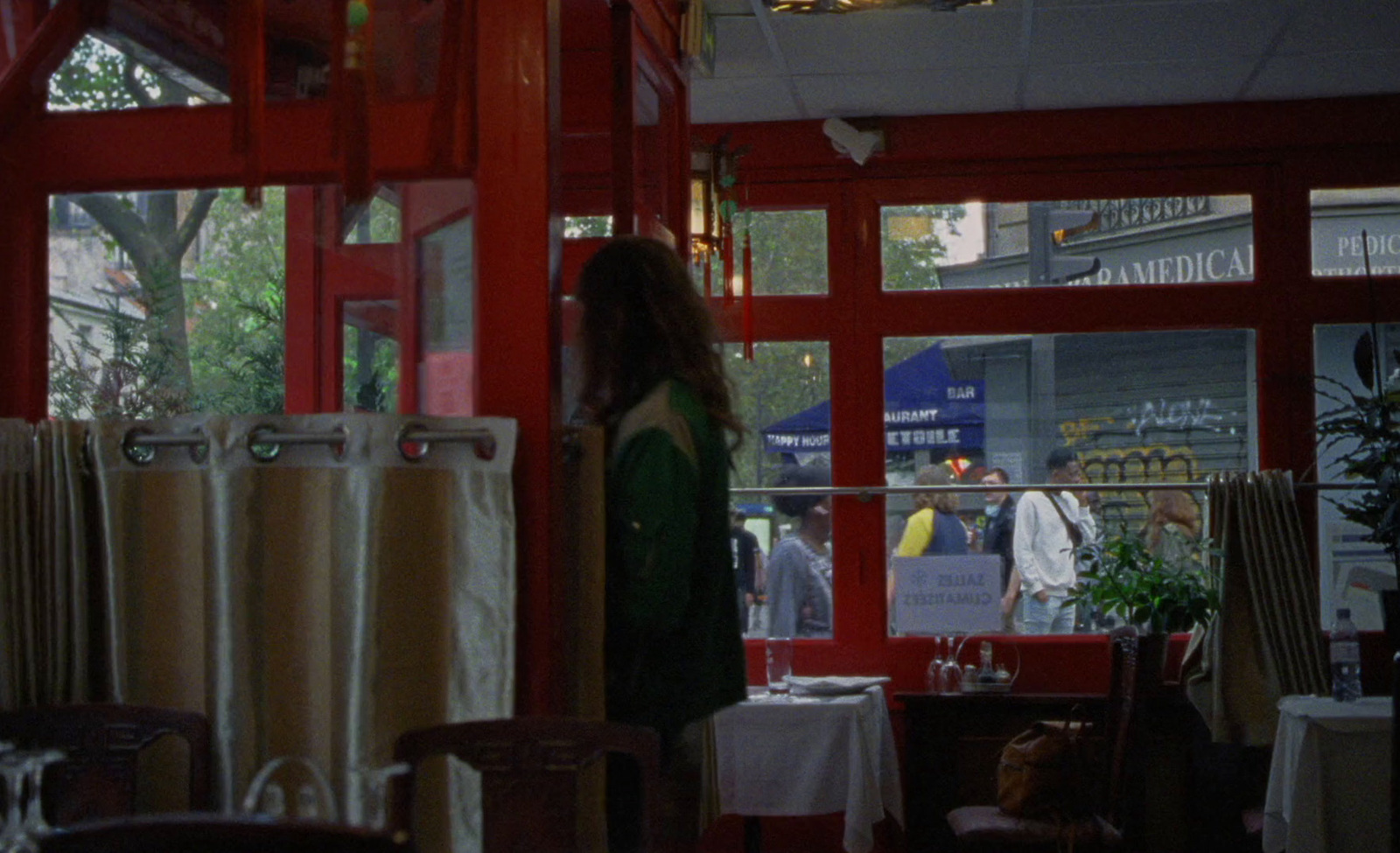 a woman standing in front of a window in a restaurant