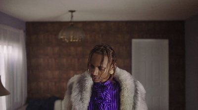 a man with dreadlocks standing in a room