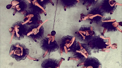 a group of dancers in black tutu skirts