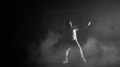 a man standing in the middle of a dark room