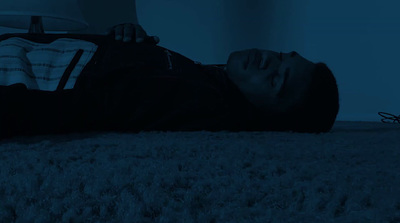 a person laying on the floor in the dark