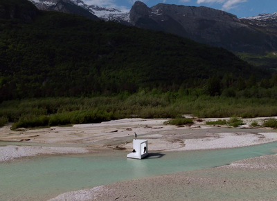 there is a small white structure in the middle of a river