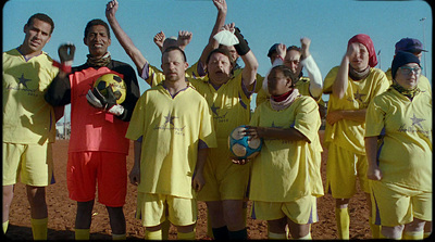 a group of men in yellow uniforms holding soccer balls