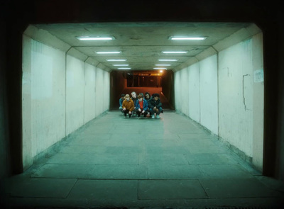 a group of people sitting on a bench in a tunnel