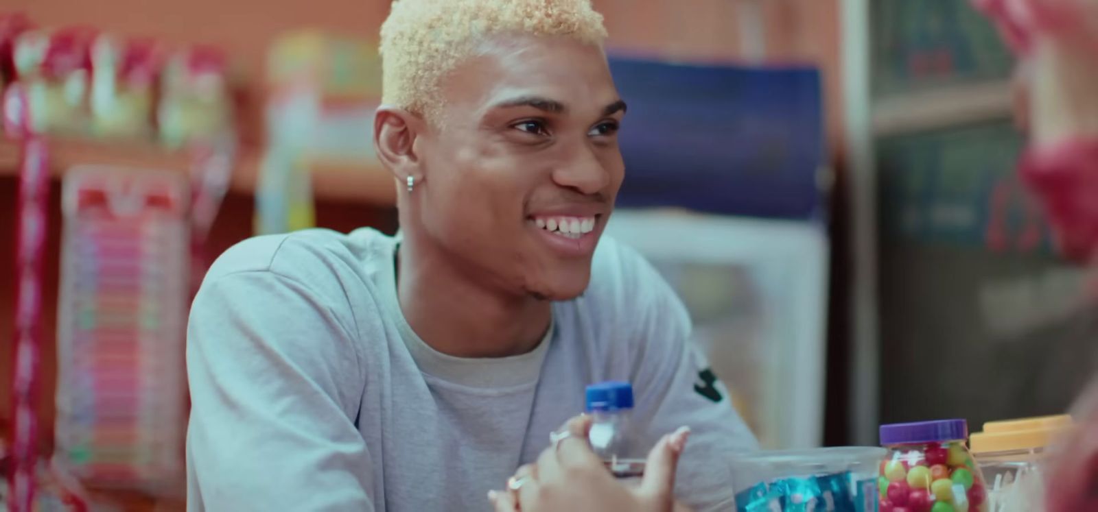 a man sitting at a table with candy in front of him