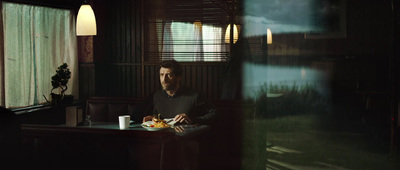 a man sitting at a table with a plate of food