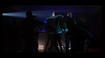 a group of people standing around in a dark room