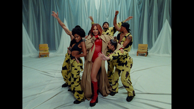 a group of women in costume standing on a stage