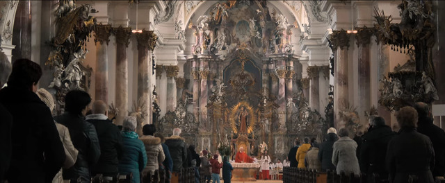 a group of people standing in front of a church