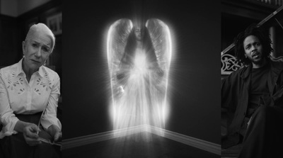 a black and white photo of a woman with angel wings