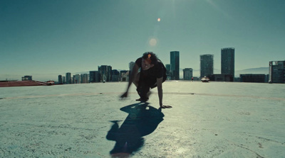 a person standing on a skateboard in a parking lot