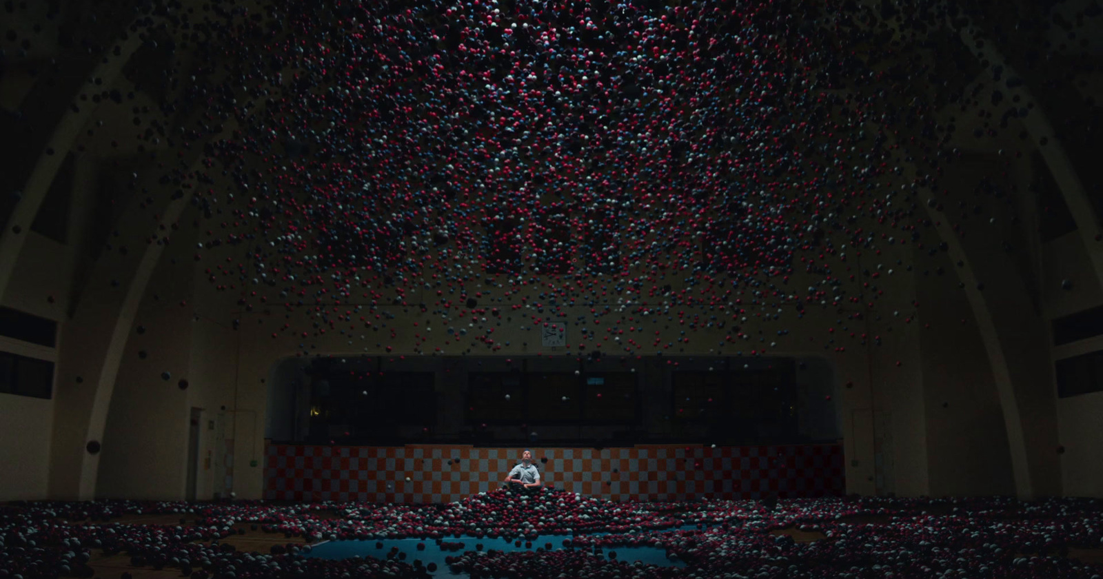 a person standing in front of a large room filled with confetti