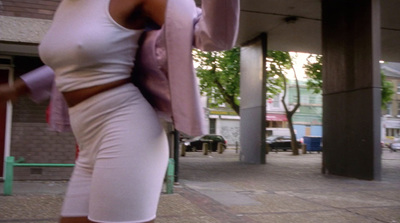 a woman in a white dress holding a pink umbrella