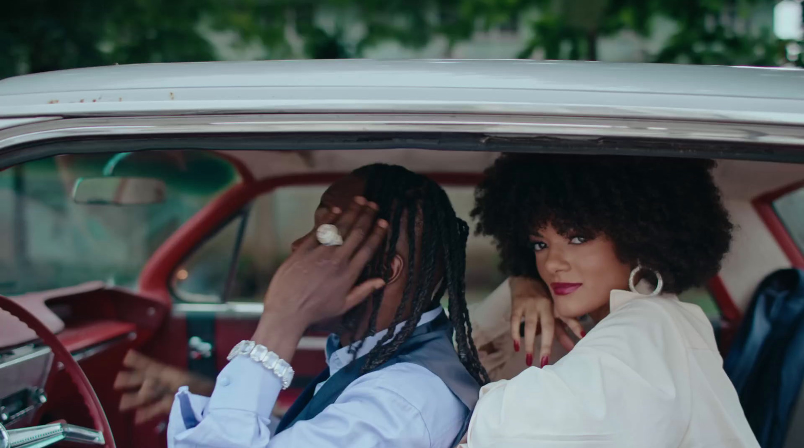 a man and a woman sitting in a car