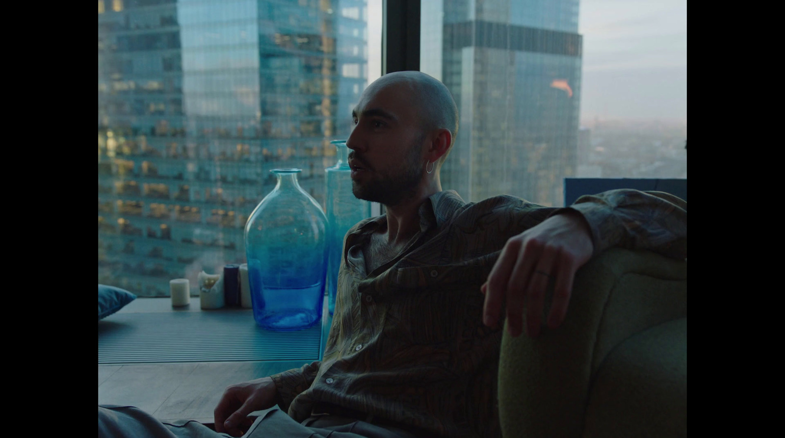 a man sitting in a chair in front of a window