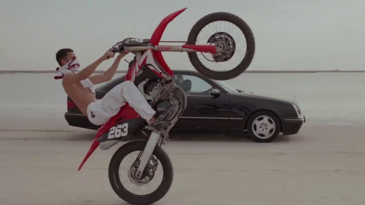 a man doing a trick on a dirt bike