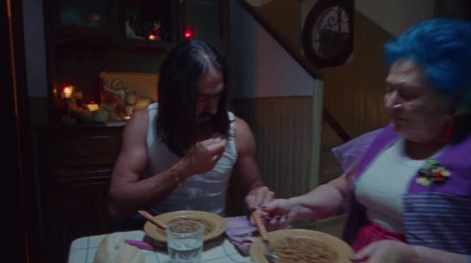 a man and a woman sitting at a table with plates of food