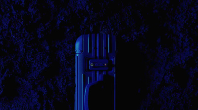 a blue piece of luggage sitting in the dark